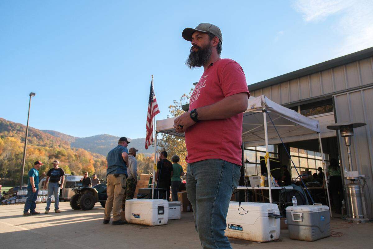 A. Austin Holmes, Savage Freedoms public relations coordinator, stands outside the temporary command center of Savage Freedoms Relief Operations in Swannanoa, N.C., on Oct. 25, 2024.