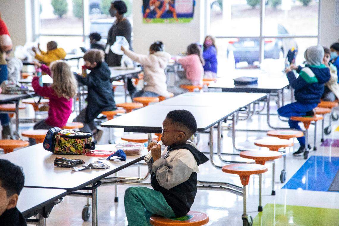 Kindergarten students at Green Elementary School, eat lunch in the cafeteriaMonday, March 15, 2021 at the Raleigh school. Monday marked the first day of daily in-person instruction in a year for Wake fourth and fifth-grade students.