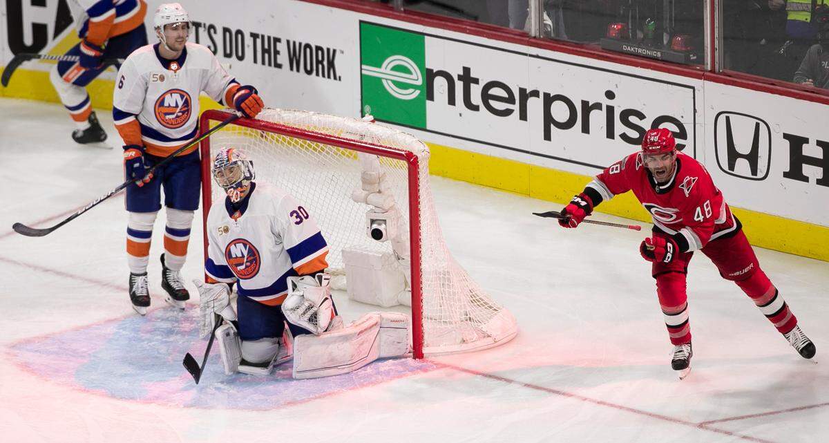 Carolina Hurricanes’ goalie Antii Raanta (32) is congratulated by teammate Stefan Noesen (23) after making 23 saves in the Hurricanes’ 4-3 victory victory over the New York Islanders on Wednesday, April 19, 2023 at PNC Arena in Raleigh, N.C.