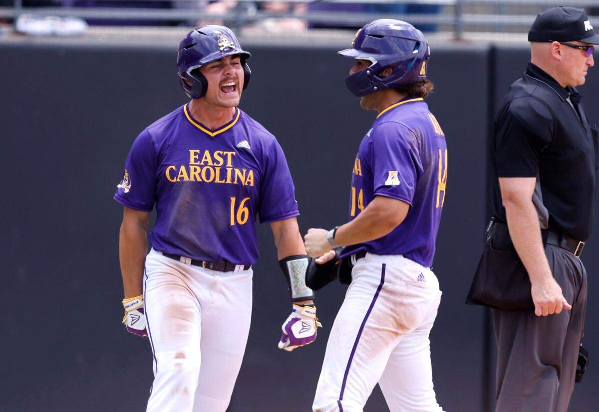 East Carolina’s Joey Rezek (16) celebrates with Zach Agnos (14) after they scored on a double by Bryson Worrell during ECUs game against Texas in the Greenville Super Regional at Clark-LeClair Stadium Saturday, June 11, 2022.