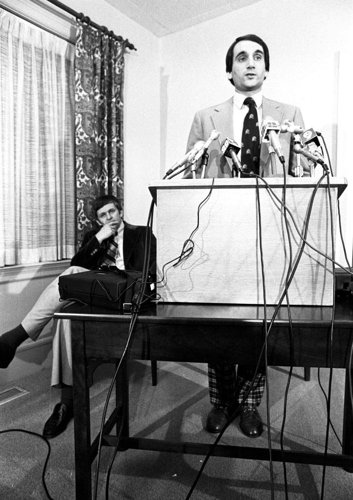 Mike Krzyzewski speaks to reporters as Duke athletic director Tom Butters (left) looks on at a press conference where the young coach from Army was introduced as the new basektball coach of the Blue Devils.