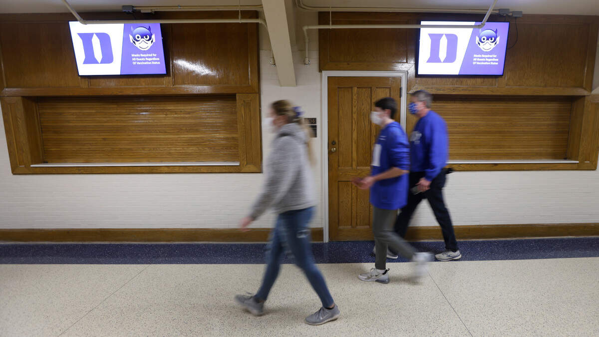 Fans walk past closed concession stands before Duke’s game against Miami at Cameron Indoor Stadium in Durham, N.C., Saturday, January 8, 2022.