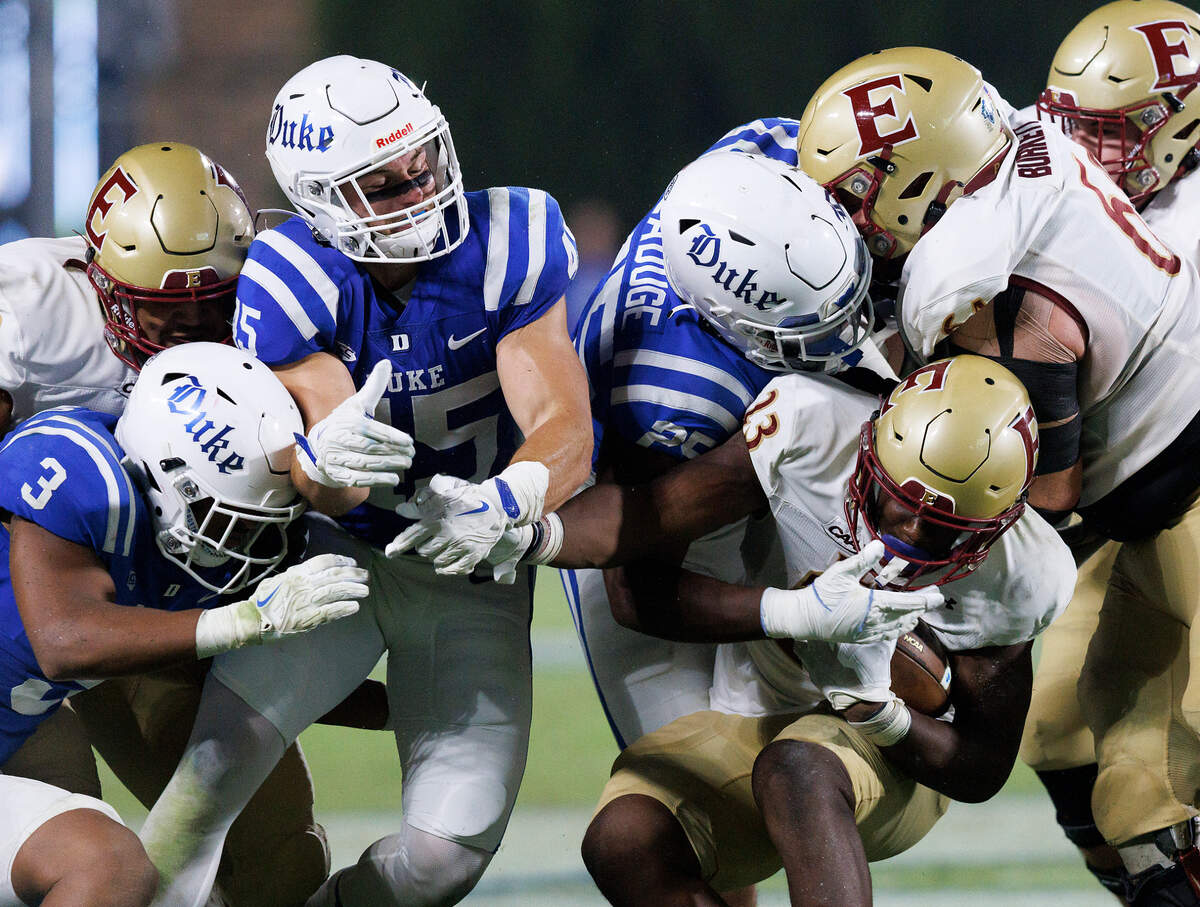 The Duke defense pressures Elon’s Rushawn Baker (23) during the second half of the Blue Devils’ 26-3 win on Friday, Aug. 30, 2024, at Wallace Wade Stadium in Durham, N.C.