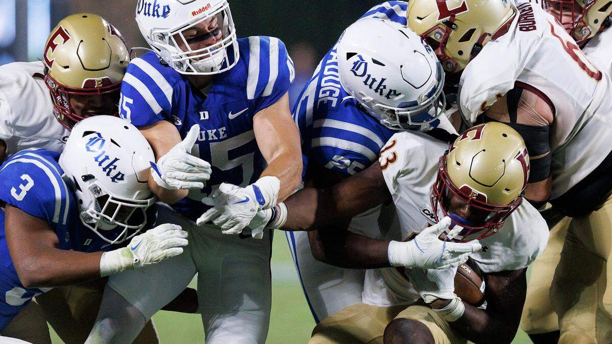 The Duke defense pressures Elon’s Rushawn Baker (23) during the second half of the Blue Devils’ 26-3 win on Friday, Aug. 30, 2024, at Wallace Wade Stadium in Durham, N.C.