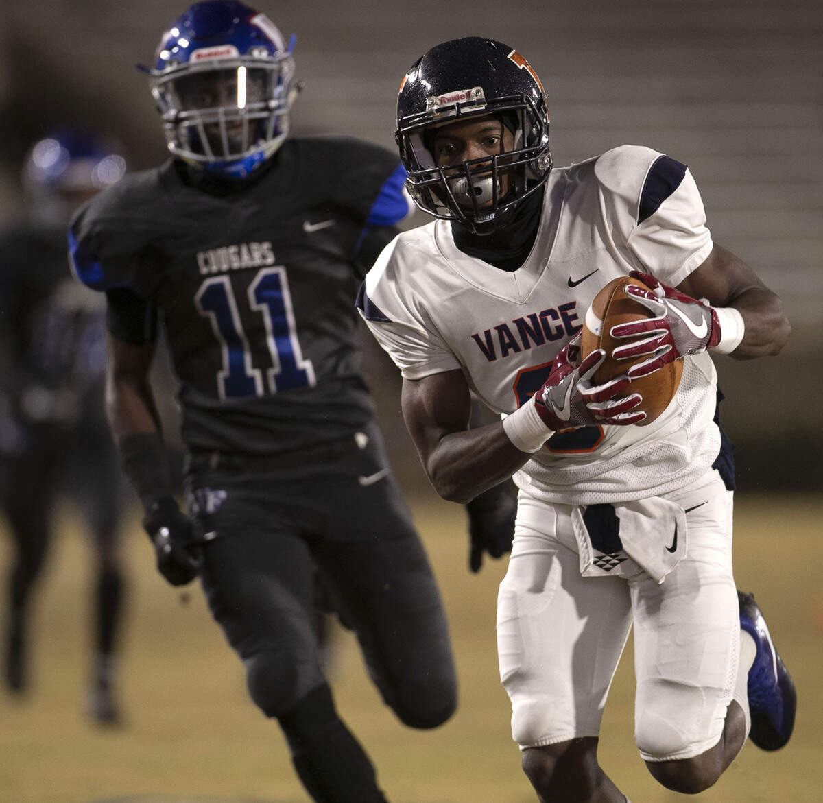 Vance’s Nyier Clark (6) races into the end zone for a touchdown on the second play from scrimmage ahead of Wake Forest’s Chance Smith (11) during the first quarter of the NCSHA State 4AA High School Football Championship on Friday, December 14, 2018 at Wallace Wade Stadium in Durham, N.C.