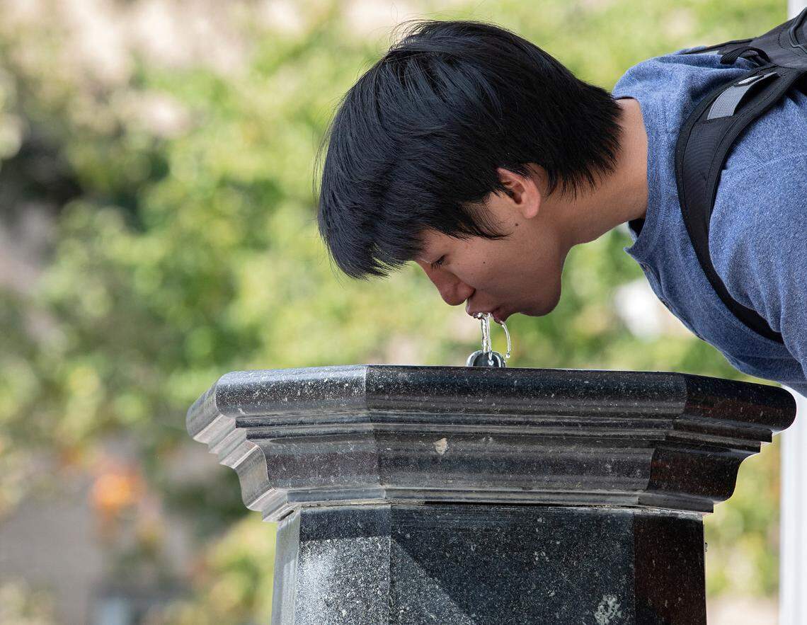 Freshman Aiden Lee drinks from the Old Well on the first day of classes at UNC-Chapel Hill on Monday, Aug. 21, 2023.