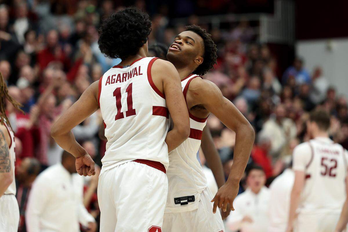 Ebuka Okorie #1 congratulates Ryan Agarwal #11 of the Stanford Cardinal after he made a three-point basket against the North Carolina Tar Heels in the final minute of the game at Stanford Maples Pavilion on January 14, 2026 in Palo Alto, California. 