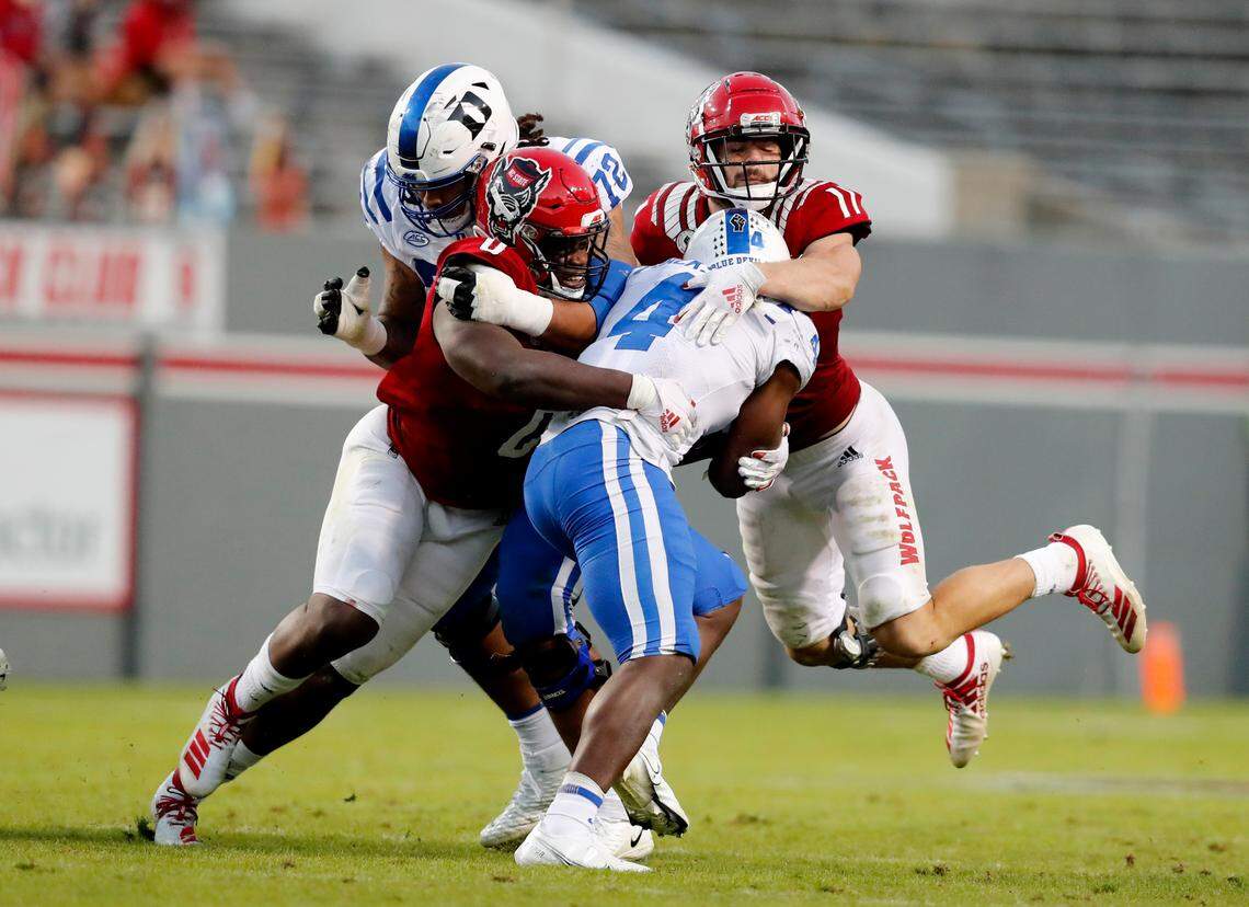 N.C. State defensive end Terrell Dawkins (0) and linebacker Payton Wilson (11) stop Duke running back Deon Jackson (4) during the second half of N.C. State’s 31-20 victory over Duke at Carter-Finley Stadium in Raleigh, N.C., Saturday, Oct. 17, 2020.