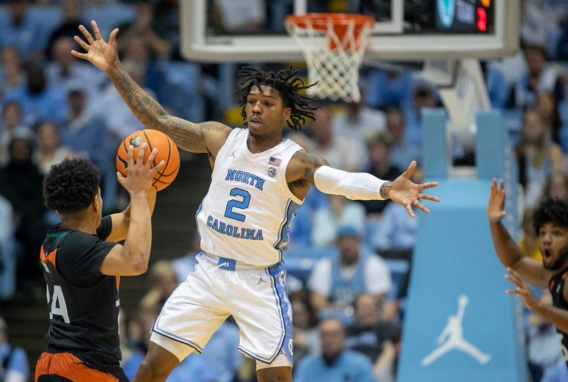 North Carolina’s Caleb Love (2) defends Miami’s Nijel Pack (24) in the second half on Monday, February 13, 2023 at the Smith Center in Chapel Hill, N.C.