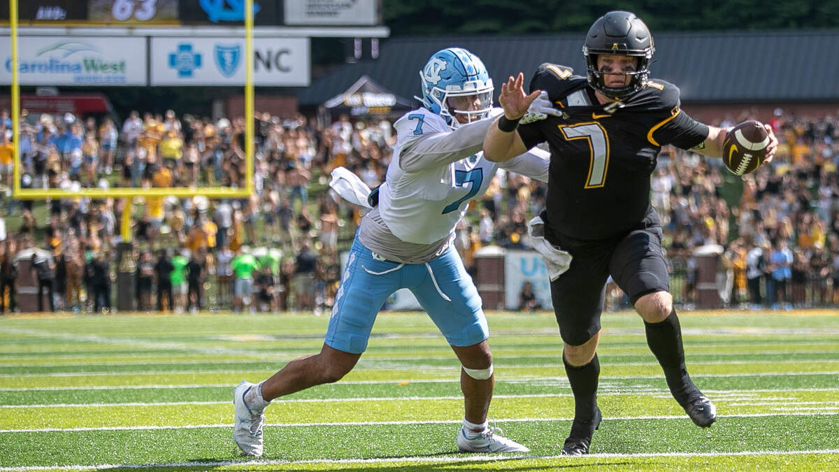 North Carolina’s Noah Taylor (7) stops Appalachian State quarterback Chase Brice at the goal line, preventing a two-point conversion and securing North Carolinaís 63-61 victory on Saturday, September 3, 2022 at Kidd Brewer Stadium in Boone, N.C.