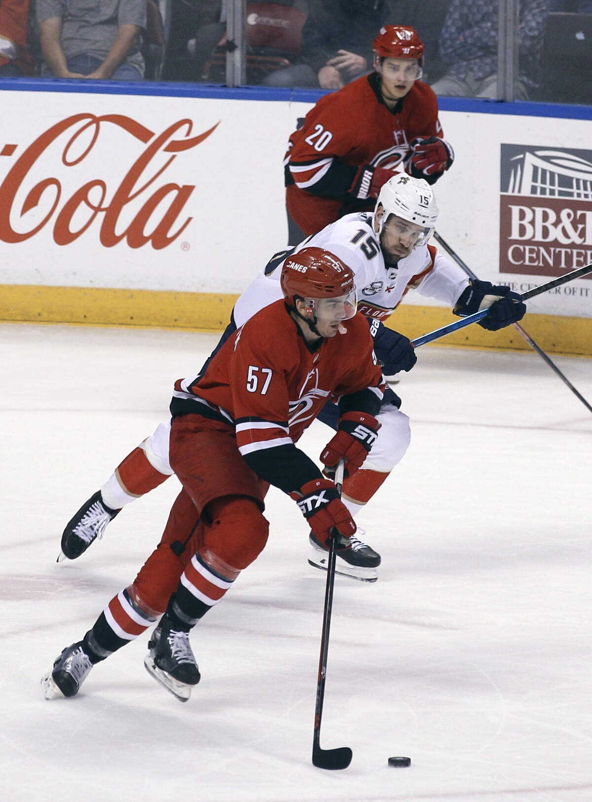 Carolina Hurricanes’ Trevor van Riemsdyk (57) takes the puck from Florida Panthers’ Riley Sheahan (15) as Carolina Hurricanes’ Sebastian Aho (20) watches during the first period of an NHL hockey game Thursday, Feb. 21, 2019, in Sunrise, Fla. (AP Photo/Luis M. Alvarez)