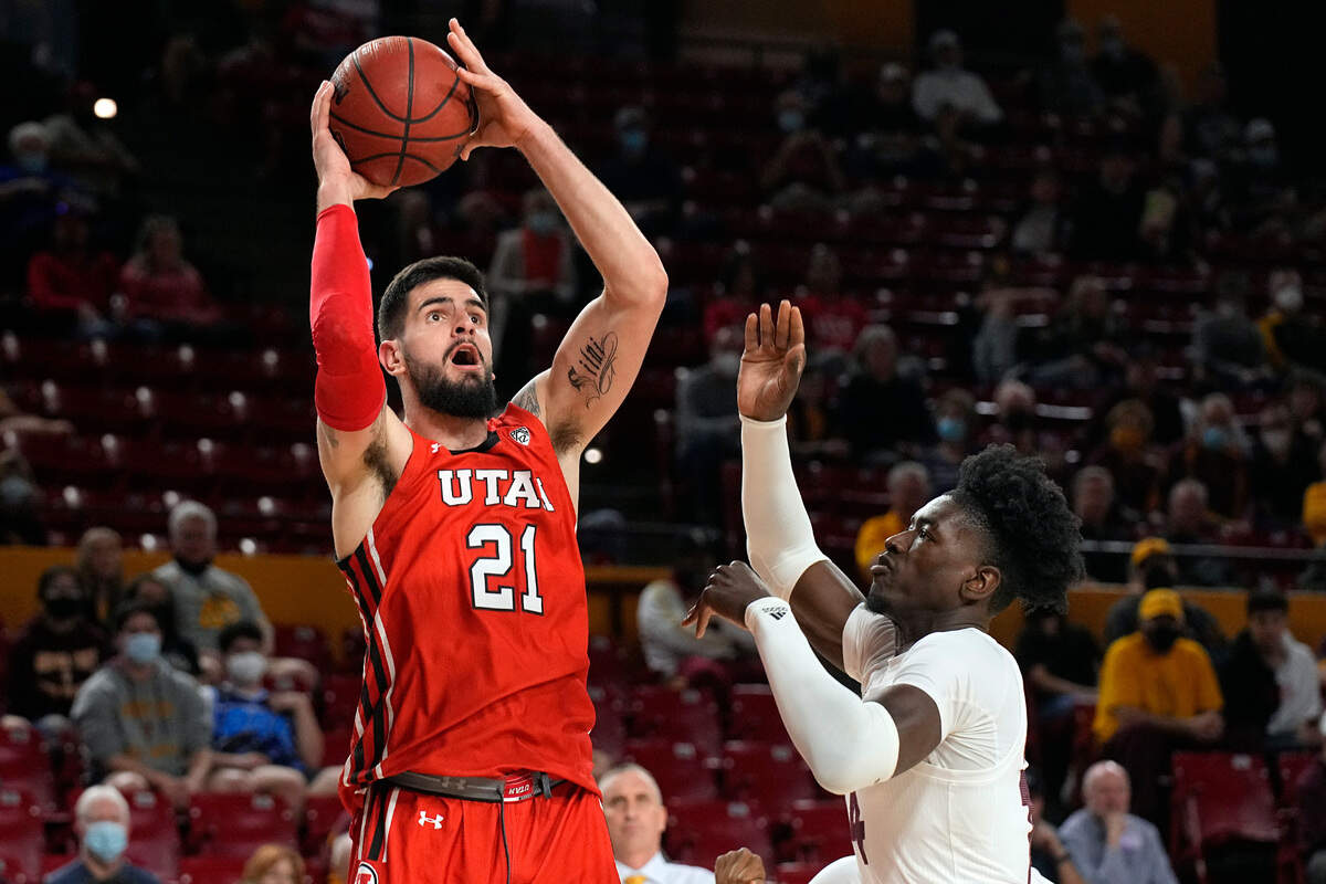 Utah forward Dusan Mahorcic (21) shoots over Arizona State center Enoch Boakye during the first half of an NCAA college basketball game, Monday, Jan. 17, 2022, in Tempe, Ariz.