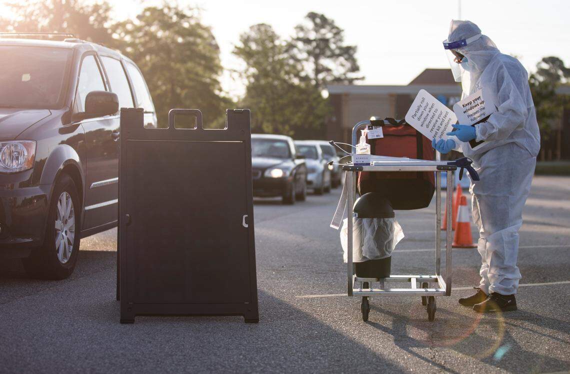 Onyx Flowers prepares to give a pre-registered individual a COVID-19 test that they will self administer in the Ramsey Street Walmart parking lot in Fayetteville, N.C. on Friday, May 15, 2020. The tests, which will be processed by eTrueNorth, are now available at this location to people who qualify and pre-register from 7a.m. to 9a.m. on Mondays, Wednesdays and Fridays.