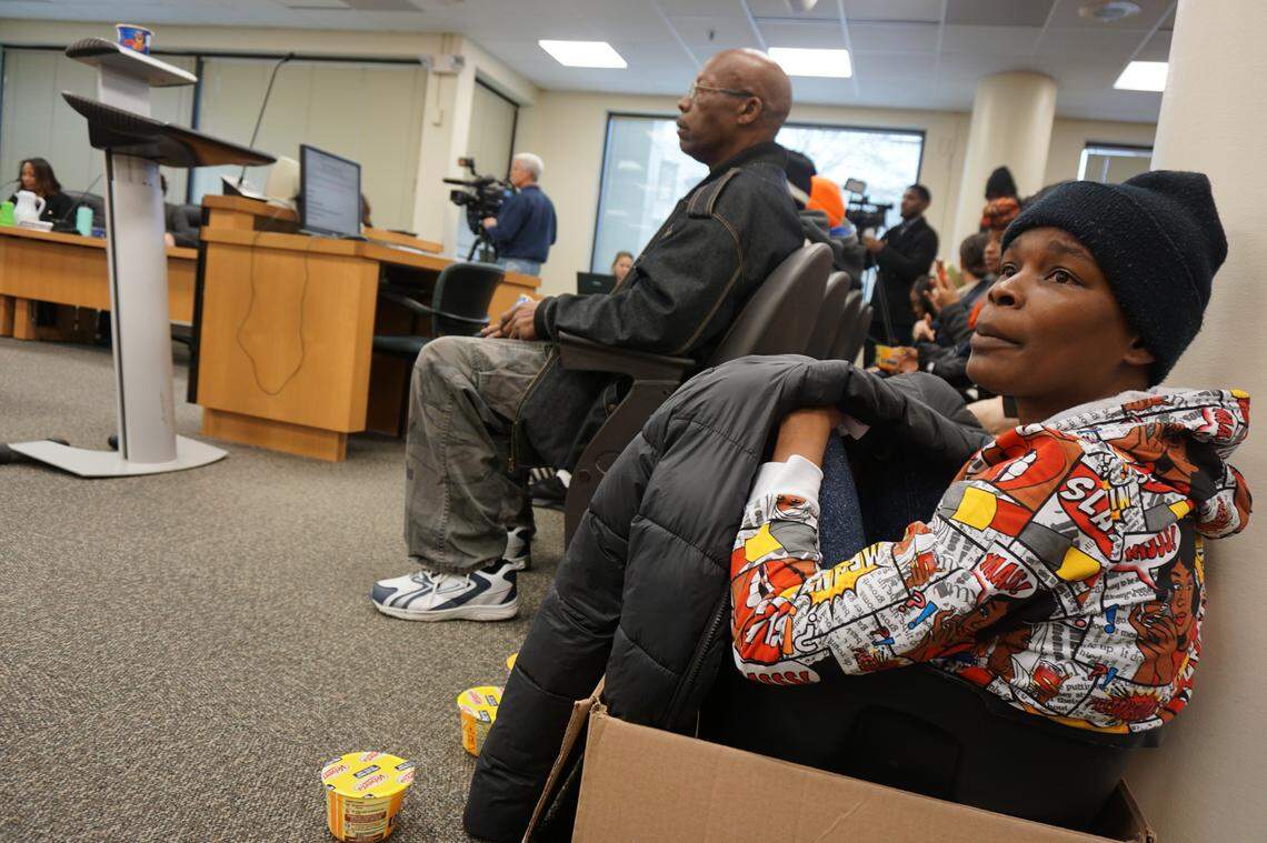 “That box represents the hotels that our kids are confined in,” said Ashley Canady, McDougald Terrace resident council president. Canady and other McDougald Terrace residents protested the extended evacuations at Thursday’s Durham city council meeting by shaking containers of mac and cheese.                              