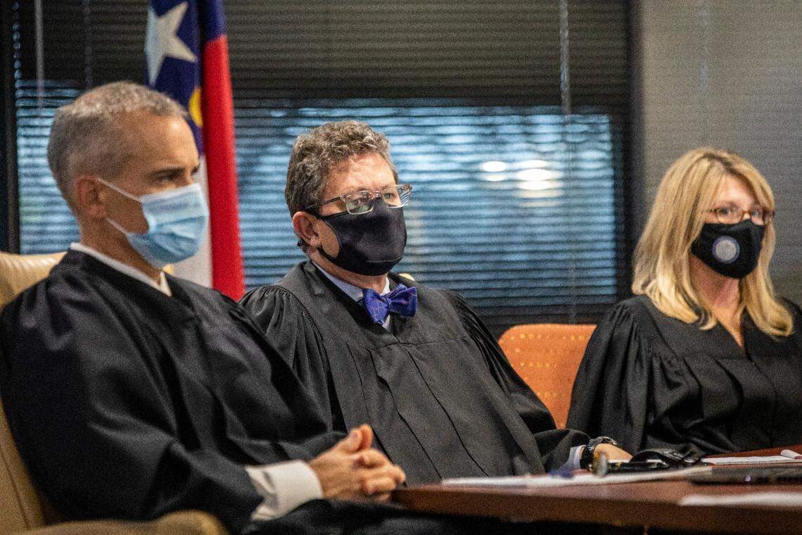 From left, Superior Court Judges Nathaniel Poovey, Graham Shirley and Dawn Layton listen to testimony from Jowei Chen, a political scientist from the University of Michigan, not pictured, during a partisan gerrymandering trial over North Carolina’s new political maps Monday, Jan. 3, 2022 at a courtroom at Campbell University School of Law in Raleigh in Raleigh, NC.