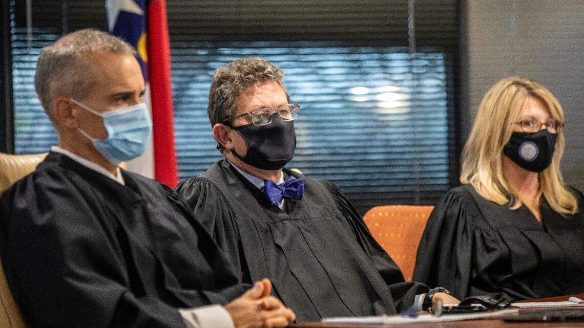 From left, Superior Court Judges Nathaniel Poovey, Graham Shirley and Dawn Layton listen to testimony from Jowei Chen, a political scientist from the University of Michigan, not pictured, during a partisan gerrymandering trial over North Carolina’s new political maps Monday, Jan. 3, 2022 at a courtroom at Campbell University School of Law in Raleigh in Raleigh, NC.