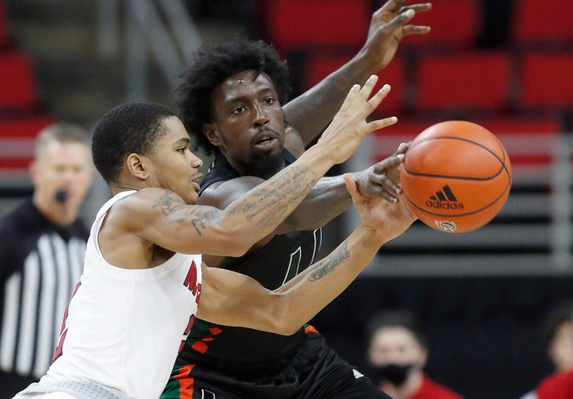 Miami’s Nysier Brooks (3) knocks the ball from the hands of N.C. State’s Shakeel Moore (2) during the second half of Miami’s 64-59 victory over N.C. State at PNC Arena in Raleigh, N.C., Saturday, January 9, 2021.