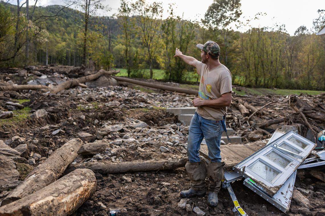 Dakota Ball looks out where a landslide came in next to his home in Barnardsville, N.C. on Wednesday, October 2, 2024.