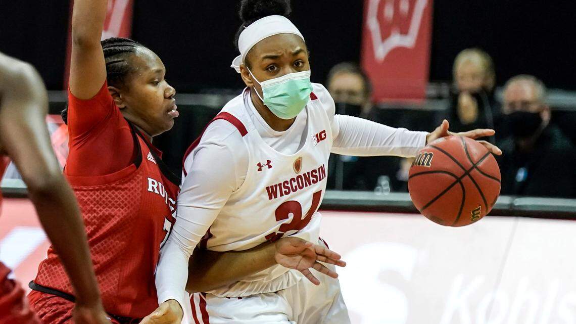 Wisconsin’s Imani Lewis (34) drives against Rutgers’ Diamond Johnson (3) during the second half of an NCAA college basketball game Friday, Dec. 11, 2020, in Madison, Wis. Rutgers won 70-65.