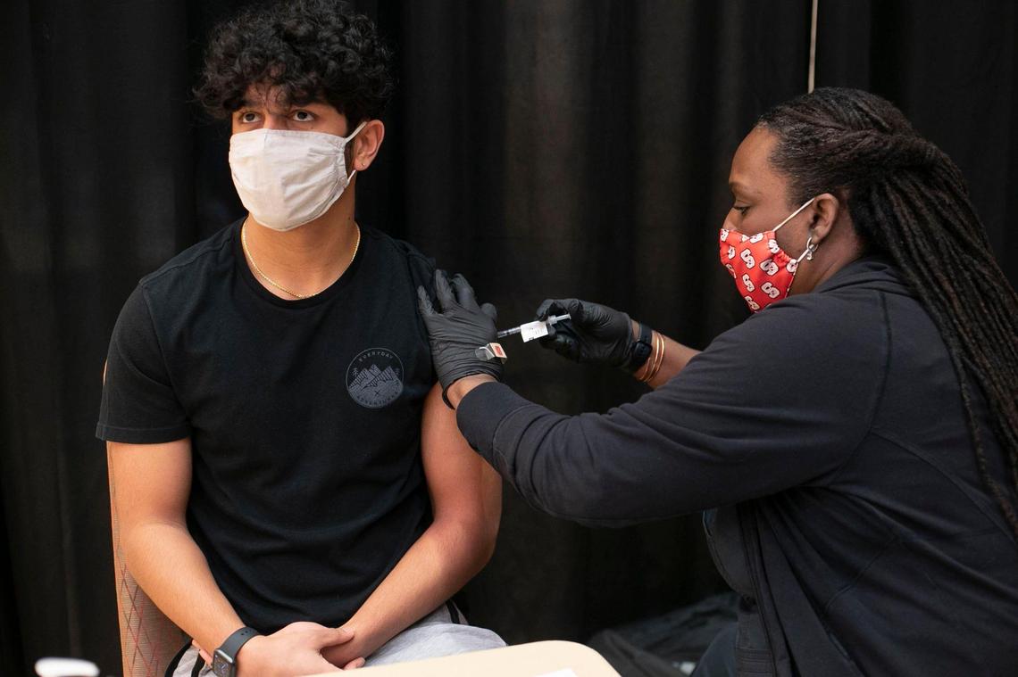 NC State student Dylan Shah receives Johnson & Johnson COVID-19 vaccination from Lynn Burton, a CCMA with Student Health Services, during a immunization clinic at NC State University’s Talley Student Union on Wednesday, March 24, 2021 in Raleigh, N.C. The clinic will deliver 150 doses of the vaccine daily to students and staff.