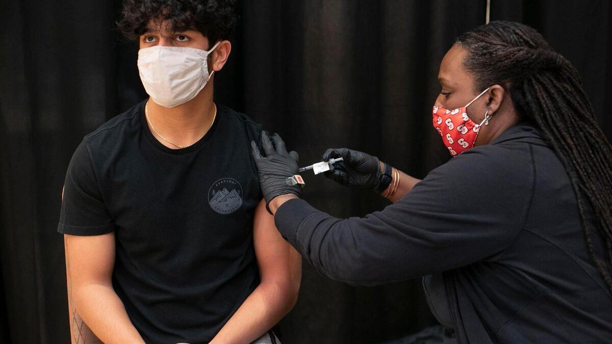 NC State student Dylan Shah receives Johnson & Johnson COVID-19 vaccination from Lynn Burton, a CCMA with Student Health Services, during a immunization clinic at NC State University’s Talley Student Union on Wednesday, March 24, 2021 in Raleigh, N.C. The clinic will deliver 150 doses of the vaccine daily to students and staff.