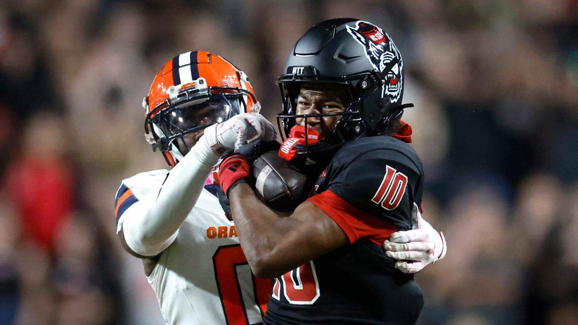 N.C. State wide receiver KC Concepcion (10) pulls in a long reception while defended by Syracuse defensive back Duce Chestnut (0) during the first half of N.C. State’s game against Syracuse at Carter-Finley Stadium in Raleigh, N.C., Saturday, Oct. 12, 2024.