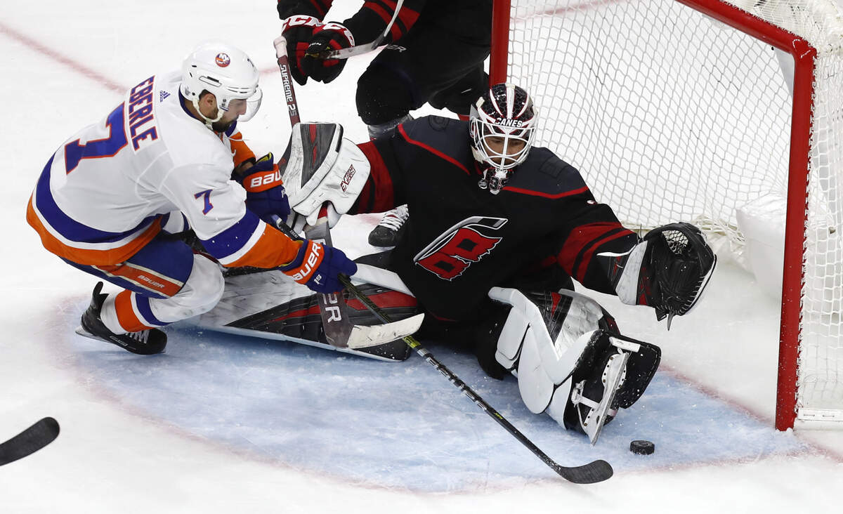 Carolina’s Curtis McElhinney (35) makes the save on a shot by New York’s Jordan Eberle (7) during the second period of the Carolina Hurricanes’ game against the New York Islanders at PNC Arena in Raleigh Wednesday, May 1, 2019.