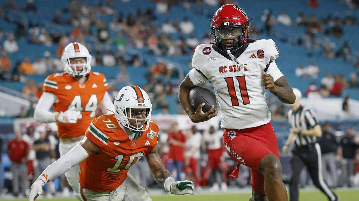 NC State quarterback CJ Bailey (11) runs in to score in the second half against the Miami Hurricanes at Hard Rock Stadium in Miami Gardens, Florida, on Saturday, November 15, 2025. 