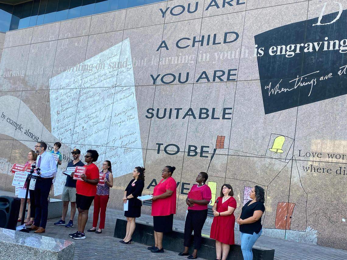 Members of the North Carolina Association of Educators stand in Halifax Mall to call for experience-based teacher pay on Tuesday,.