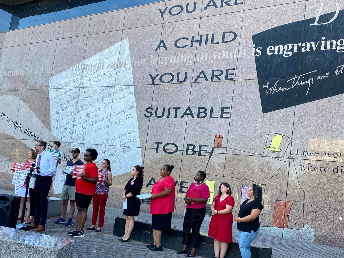 Members of the North Carolina Association of Educators stand in Hallifax Mall to call for experience-based teacher pay.