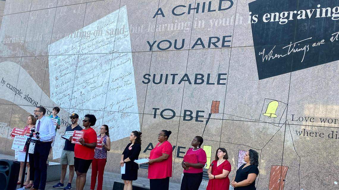 Members of the North Carolina Association of Educators stand in Halifax Mall to call for experience-based teacher pay on Tuesday,.
