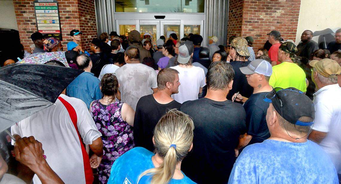Hundreds line up as a Harris Teeter opened it’s doors Saturday, September 15, 2018 in Wilmington, N.C.  which is remains mostly powerless as Tropical Storm Florence continued to pelt the area with rain and wind