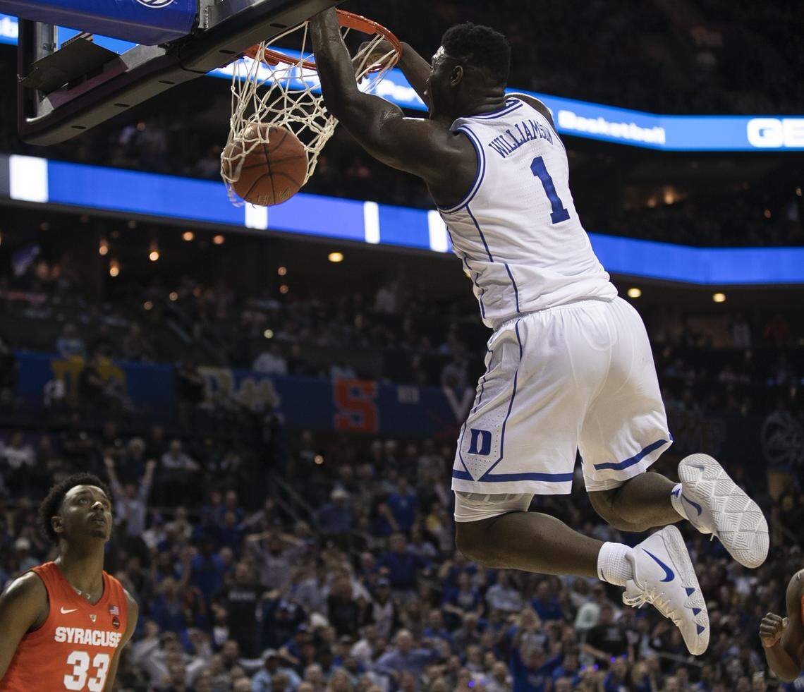 Duke’s Zion Williamson (1) goes to the basket for a dunk over Syracuse’s Elijah Hughes (33) in the first half on Thursday, March 14, 2019 during quarter finals of the ACC Tournament at Spectrum Center in Charlotte, N.C.
