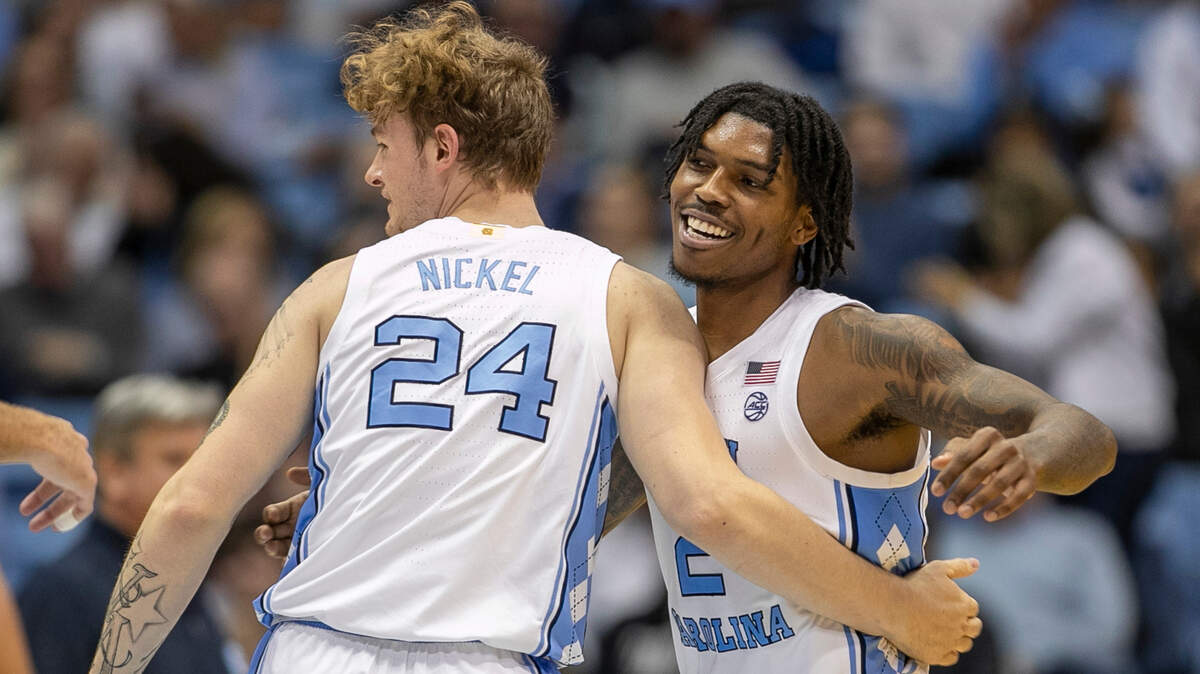 North Carolina’s Caleb Love (2) embraces Tyler Nickel (24) after Nickel sank a three-point basket to give the Tar Heels’ a 65-39 lead in the second half against The Citadel on Tuesday, December 13, 2022 at the Smith Center in Chapel Hill, N.C.