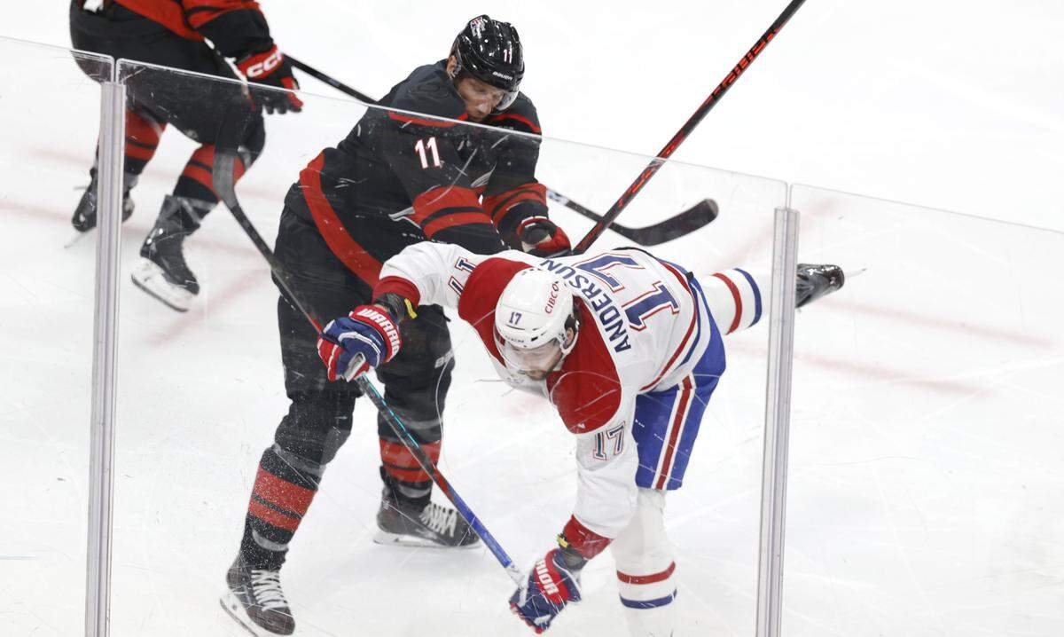Carolina's Jordan Staal (11) checks Montréal's Josh Anderson (17) during the second period of the Hurricanes’ game against the Canadiens in game one of the Eastern Conference Finals at the Lenovo Center Thursday, May, 21, 2026.
