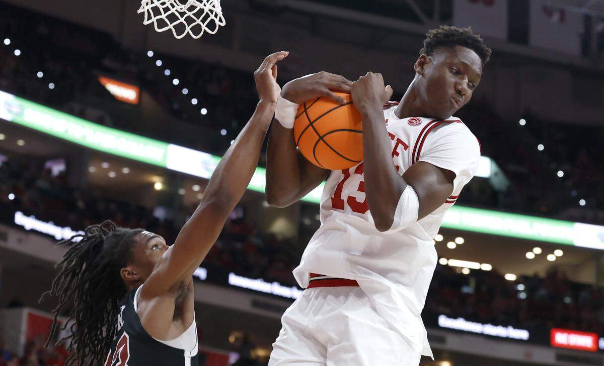 N.C. State's Musa Sagnia (13) pulls in a rebound during N.C. State’s game against N.C. Central University at the Lenovo Center in Raleigh, N.C., Monday, Nov. 3, 2025.