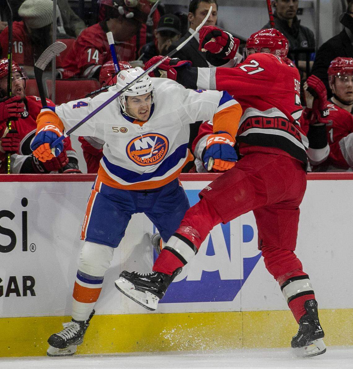 Carolina Hurricanes Derek Stepan (21) checks New York Islanders’ Samuel Bolduc (4) during the first period in game one of their Stanley Cup playoff series on Monday, April 17, 2023 at PNC Arena in Raleigh, N.C.