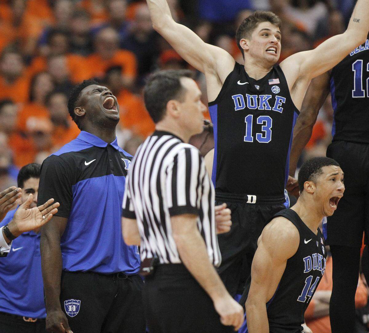 Duke’s Zion Williamson, left, and teammates cheer after a Duke basket during the second half of an NCAA college basketball game against Syracuse in Syracuse, N.Y., Saturday, Feb. 23, 2019. Duke won 75-65.