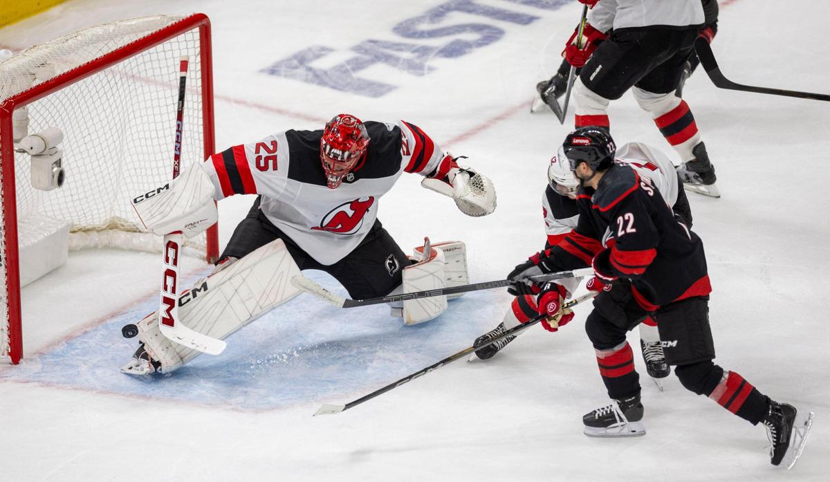 New Jersey Devils’ goalie Jacob Markstrom (25) deflects a shot by Carolina Hurricanes center Logan Stankoven (22) in the third period during Game 5 of their Stanely Cup series on Tuesday, April 29, 2025 at Lenovo Center in Raleigh, N.C.
