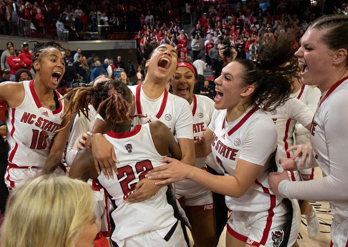 N.C. State players celebrate after defeating UConn 92-81 on Sunday, Nov. 12, 2023, at Reynolds Coliseum in Raleigh, N.C.
