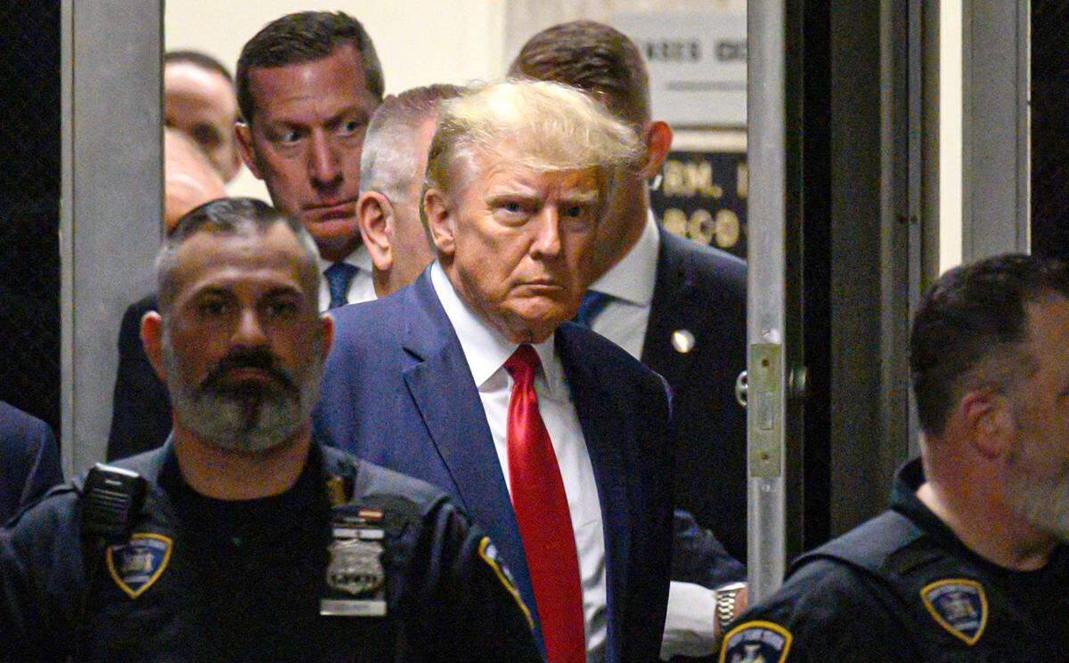 Former U.S. President Donald Trump makes his way inside the Manhattan Criminal Courthouse in New York on Tuesday, April 4, 2023.