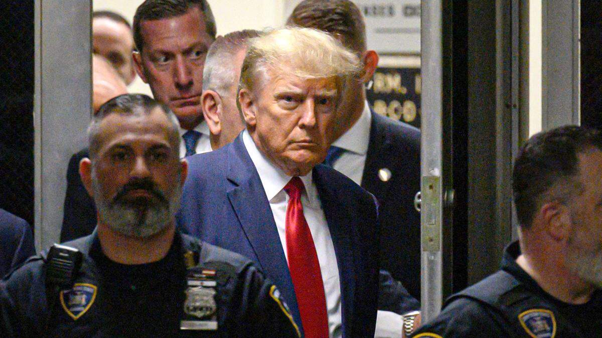 Former U.S. President Donald Trump makes his way inside the Manhattan Criminal Courthouse in New York on Tuesday, April 4, 2023.
