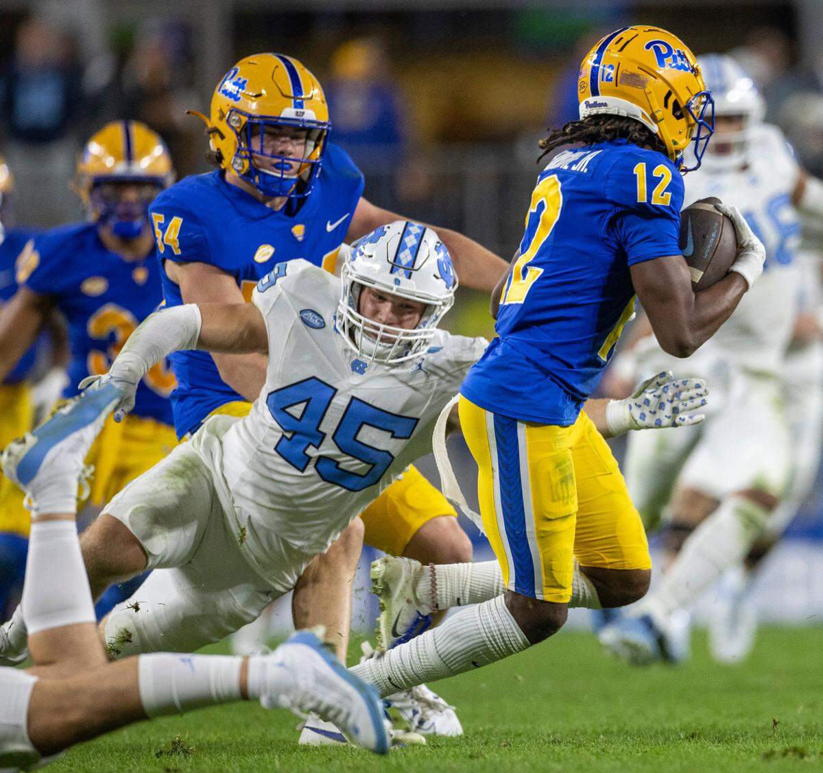 North Carolina’s Jake Harkleroad (45) stops Pitt’s M.J. Devonshire (12) for a one-yard gain on a punt return in the fourth quarter on Saturday, September 23, 2023 at Acrisure Stadium in Pittsburgh, Pa.