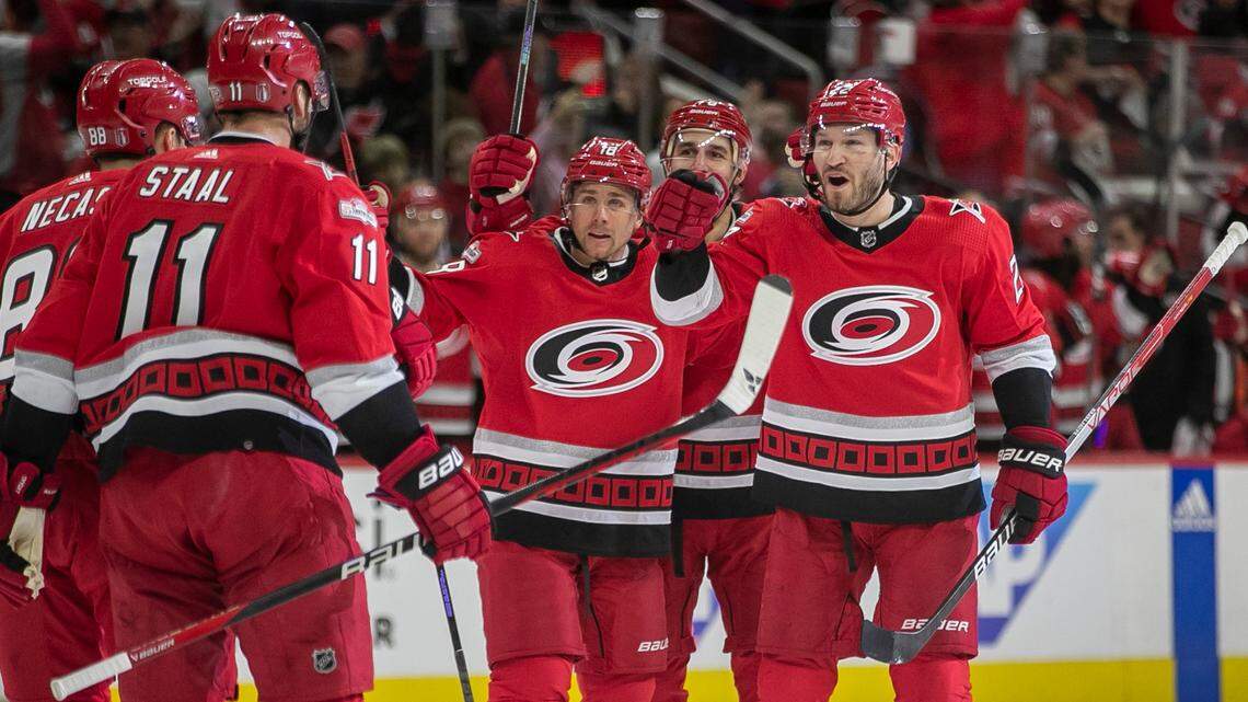 The Carolina Hurricanes Brett Pesce (22) congratulates teammate Jordan Staal (11) after an assist on Pesce’s goal on New Jersey Devils goalie Akira Schmid (40) in the first period during Game 1 of their second round Stanley Cup playoff series on Wednesday, May 3, 2023 at PNC Arena in Raleigh, N.C.