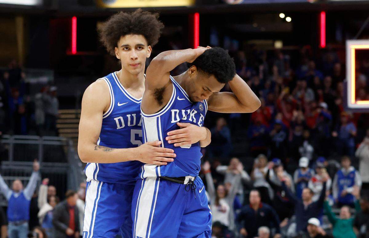 Duke’s Tyrese Proctor (5) and Jeremy Roach (3) walk towards the bench after Kansas’ 69-64 victory over Duke in the State Farm Champions Classic in Indianapolis, Ind. Tuesday, Nov. 15, 2022.