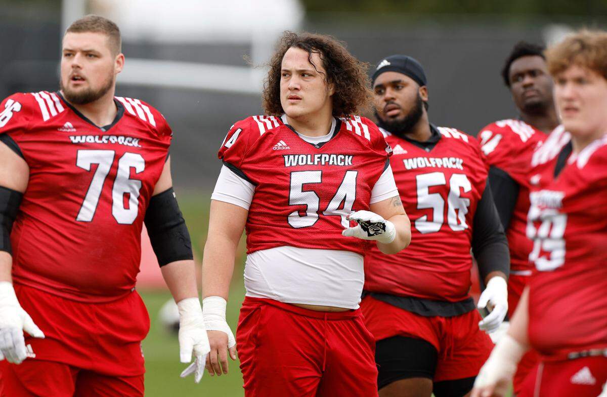 N.C. State offensive linemen Patrick Matan (76), Dylan McMahon (54) and Lyndon Cooper (56) look for the play during the Wolfpack’s first spring practice in Raleigh, N.C., Wednesday, March 1, 2023.