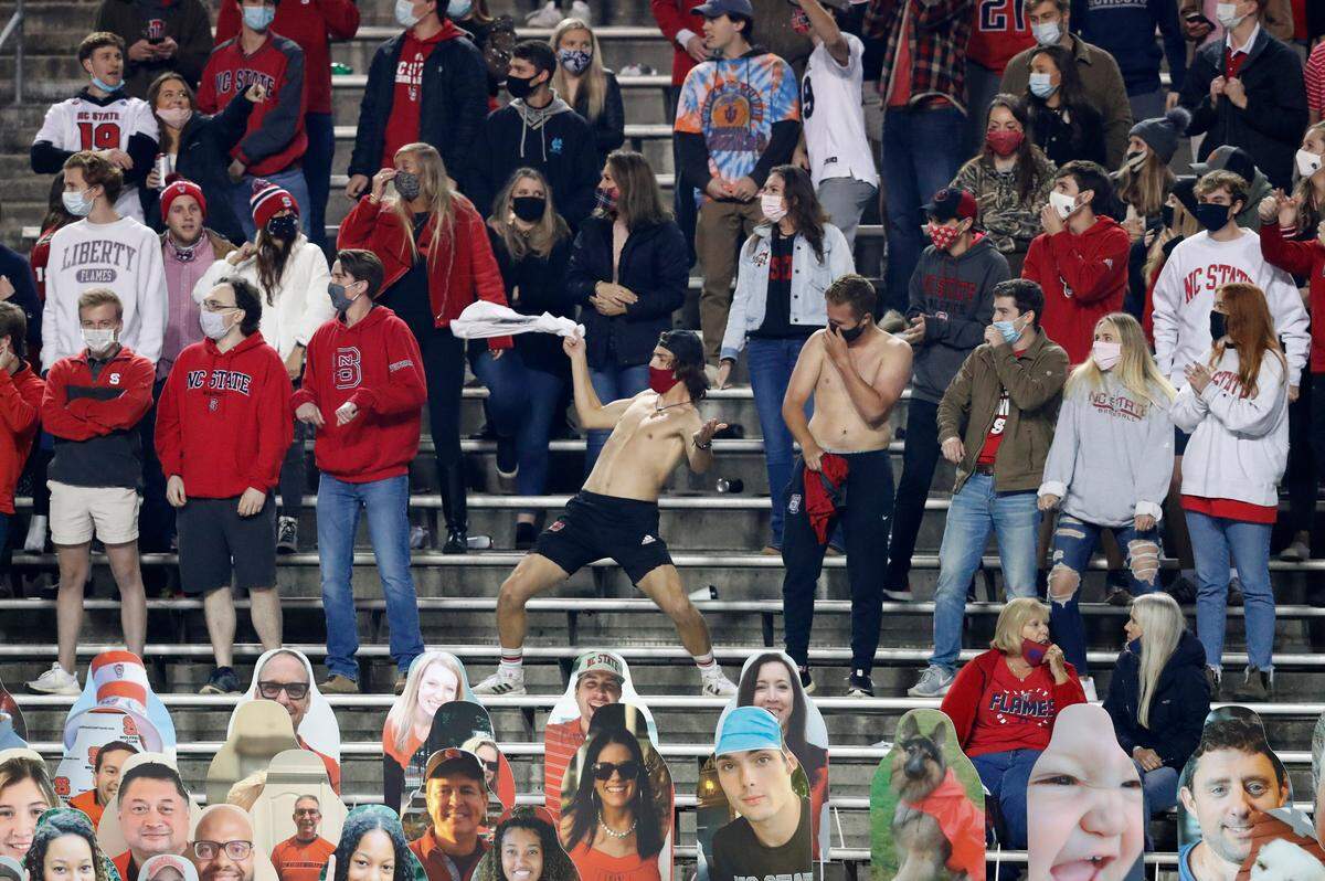 Wolfpack fans cheers on the team during the second half of N.C. State’s 15-14 victory over Liberty at Carter-Finley Stadium in Raleigh, N.C., Saturday, Nov. 21, 2020.