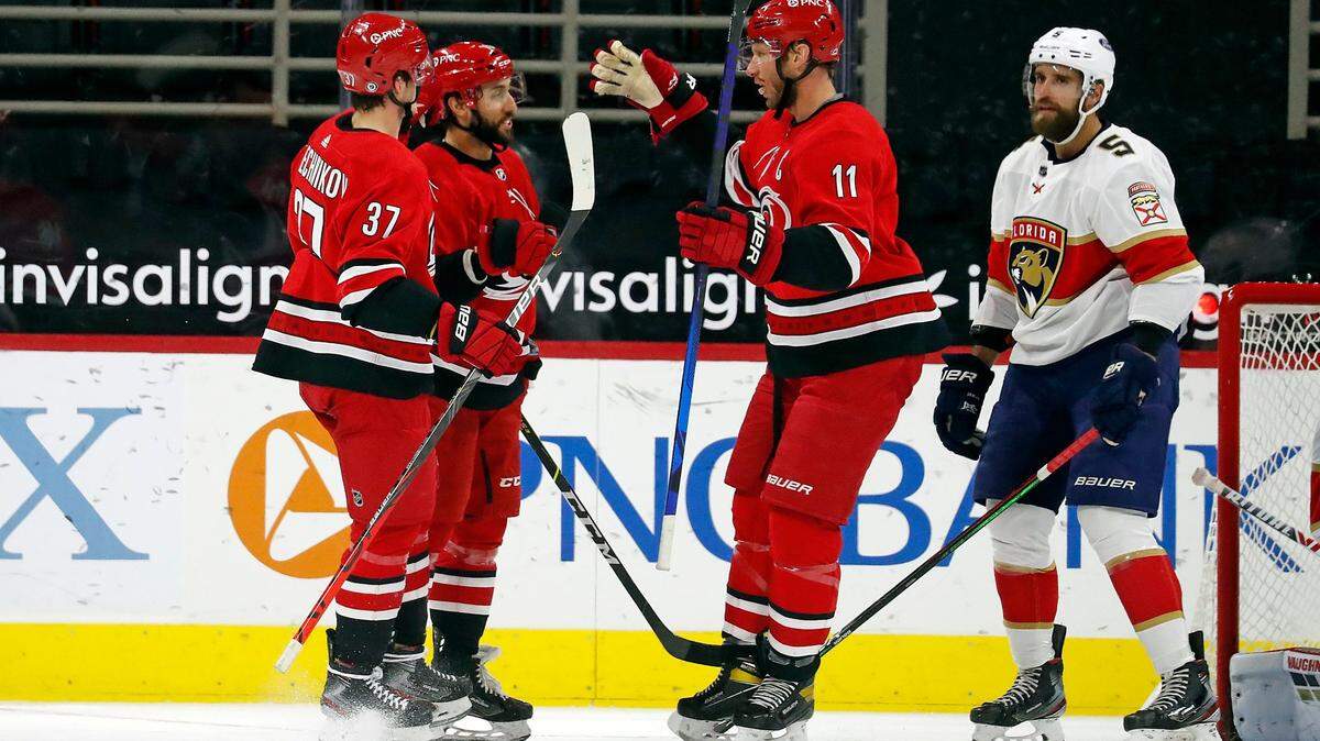 Carolina Hurricanes’ Vincent Trocheck (16), center, is congratulated on his goal by teammates Jordan Staal (11) and Andrei Svechnikov (37) with Florida Panthers’ Aaron Ekblad (5) nearby during the first period of an NHL hockey game in Raleigh, N.C., Sunday, March 7, 2021. (AP Photo/Karl B DeBlaker)