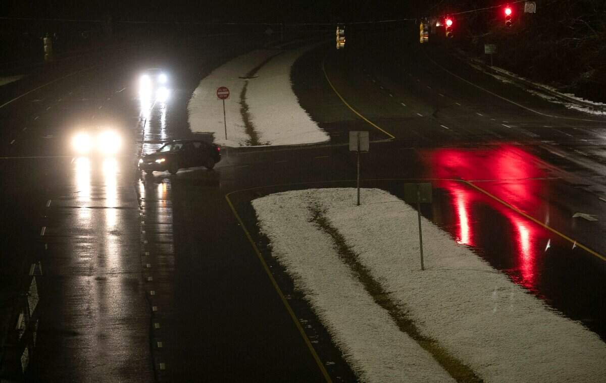 A light dusting of snow blankets only the grassy media on Hammond Road after a winter storm moved through the Triangle in the early morning hours of Thursday, January 28, 2021in Raleigh, N.C.