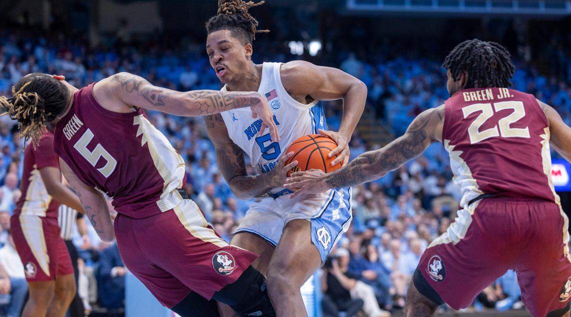 North Carolina’s Armando Bacot (5) collides with Florida State’s De’Ante Green (5) in the first half on Saturday, December 2, 2023 at the Smith Center in Chapel Hill, N.C.